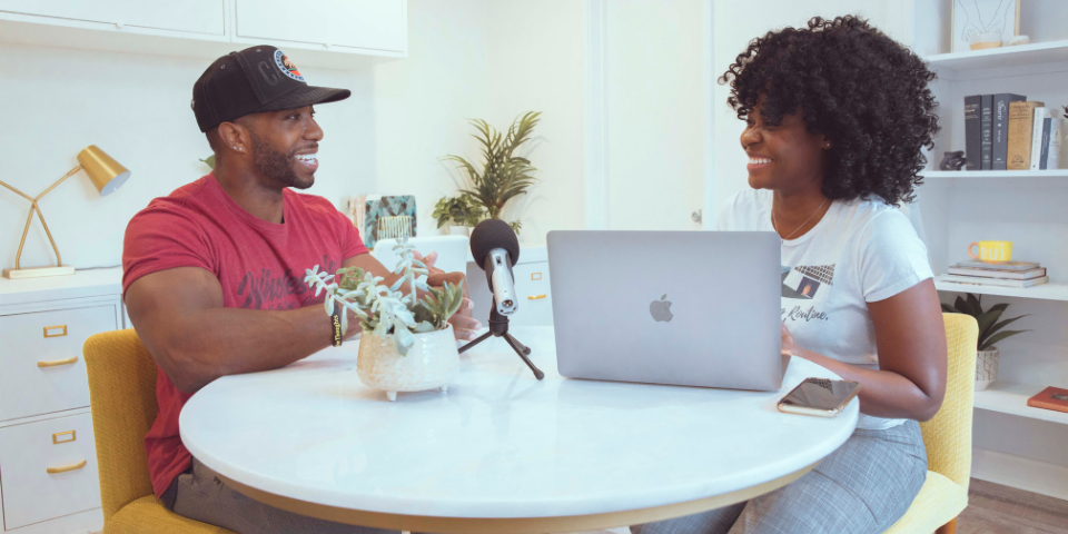 Show Up & Grow Your Business​: two people talking over table